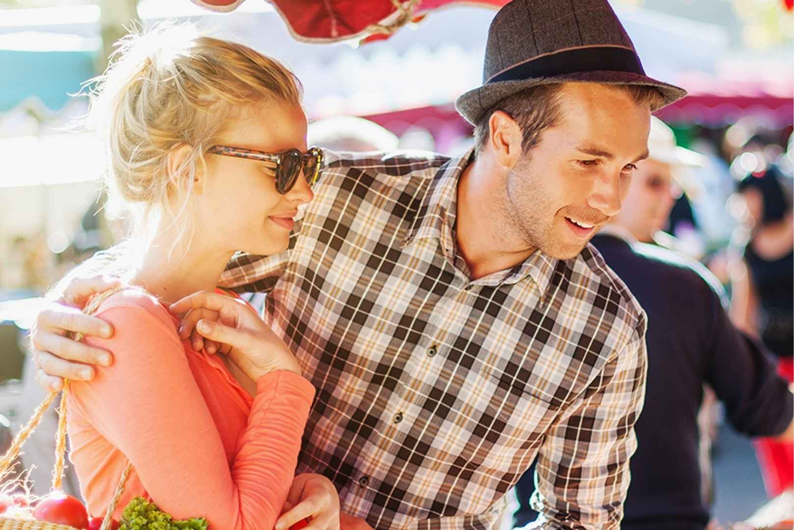 A happy couple shops at an outdoor market