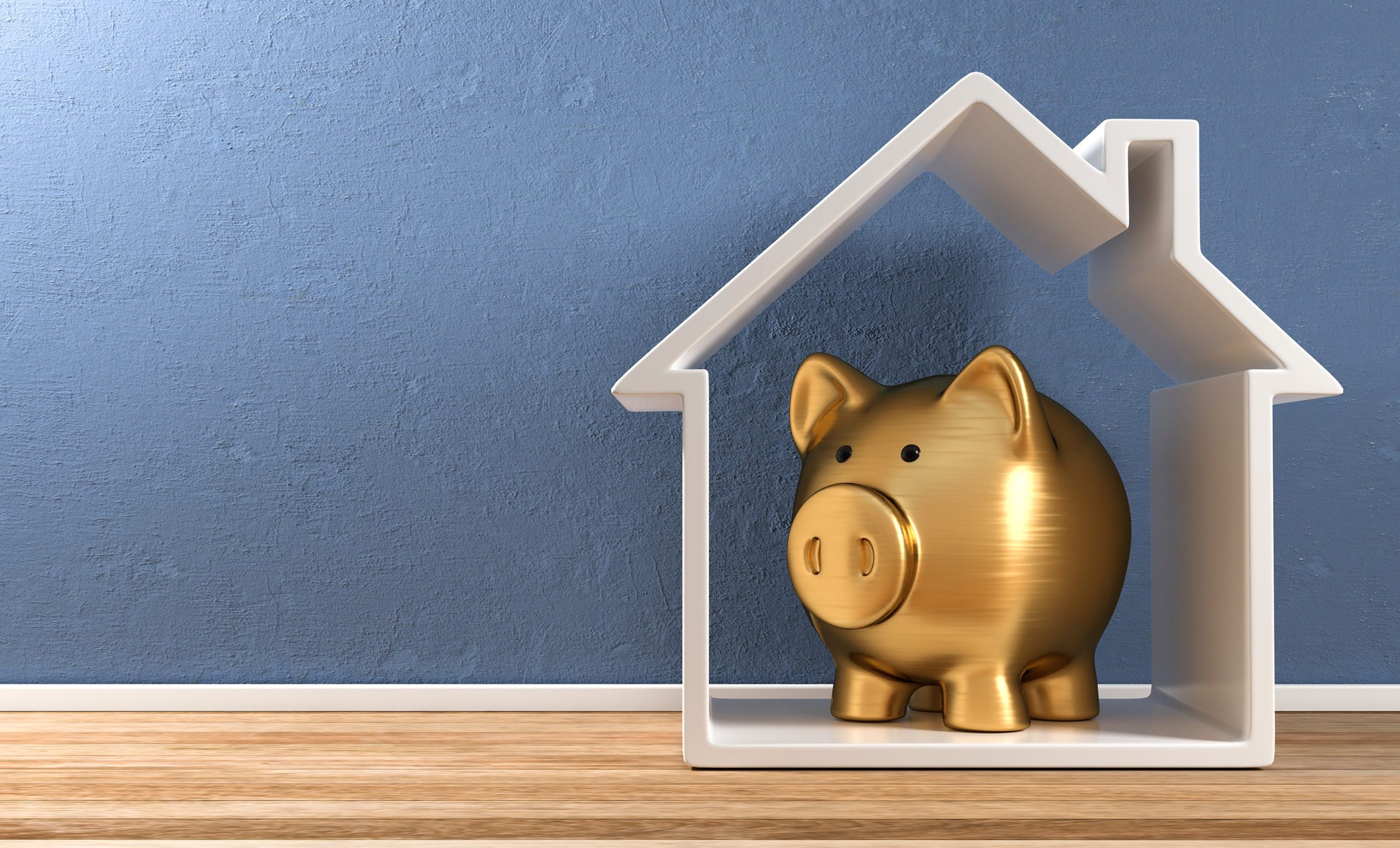 A golden piggy bank sits inside a white house outline by a textured blue wall.