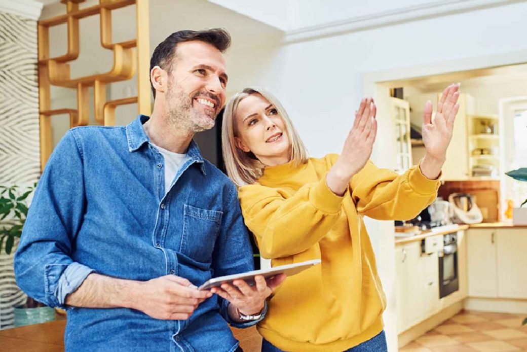 A couple standing in the living room of their new home